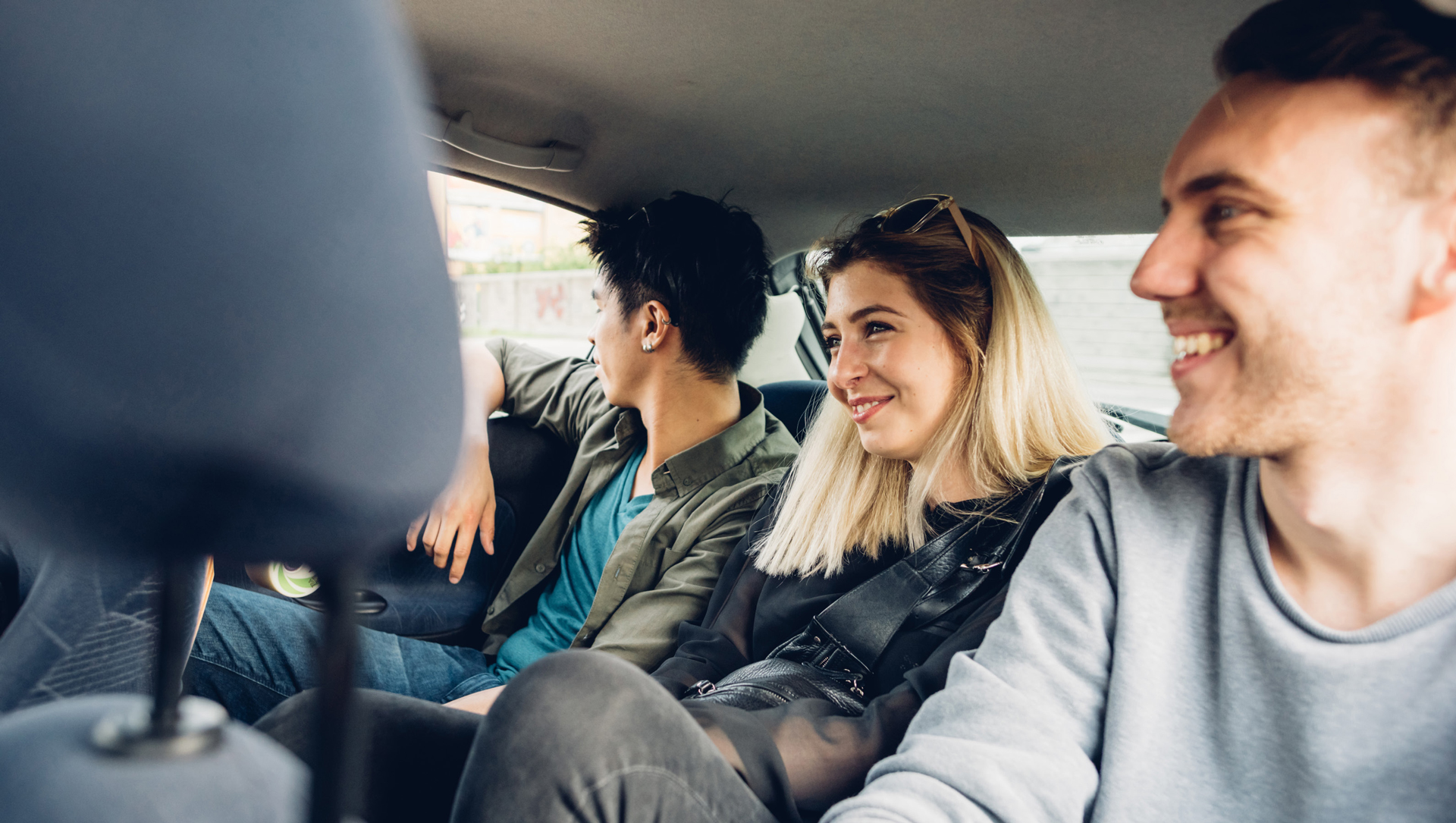 Young people in the back of a car